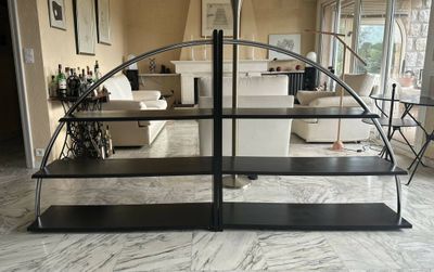 a black shelf with a mirror on it in a living room