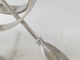 a silver metal object with an arrow on it