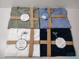 three men ' s t - shirts wrapped in brown paper with tags on them