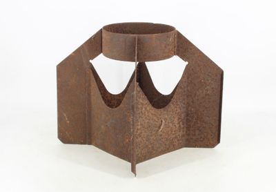 a metal sculpture of a face on a white background