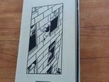 the book is sitting on a wooden table next to a window