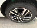 a close up of a tire on a white car