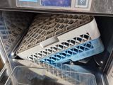 a dishwasher with a basket in it that is inside of an oven