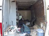 a white van that has a lot of trash in the back