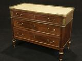 an antique chest of drawers with marble top and brass trim