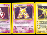 two pokemon cards with different designs on them on a black background