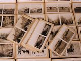 many old black and white photographs on the table
