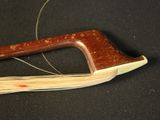 a close up of a wooden instrument on a black surface
