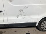 a van that has been vandalized and is parked on the side of the road