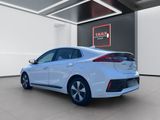 the rear of a white toyota prius parked in a showroom