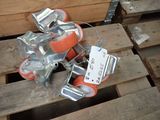 a pile of orange and silver rollers on a pallet