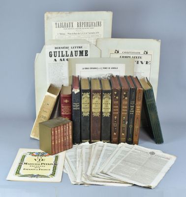 an assortment of old books and pamphlets on a table