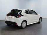 the back end of a white toyota ay parked in a room