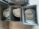 a stack of plates and bowls in a metal box