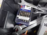 two wrenches and a can of wrench in a toolbox