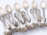 six silver spoons and two silver spoons on a white surface