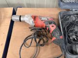 a corded drill and a corded cord in a tool box