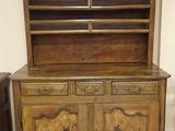 a wooden cabinet with two drawers on top of it