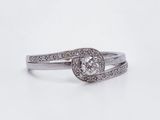 a close up of a diamond ring on a white background