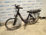 a bike that is parked in front of a wall