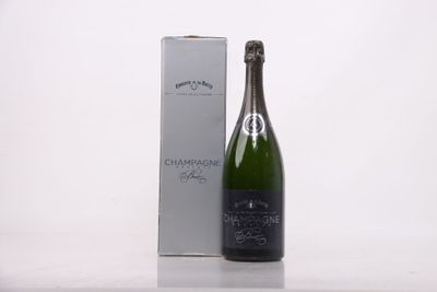 a bottle of champagne next to a box on a table