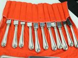 a set of knives and a knife roll on a table