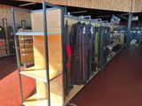 a lot of clothes that are on display in a store