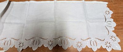 a table with a white table cloth and a pair of scissors on it
