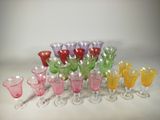 a lot of different colored glasses on the table