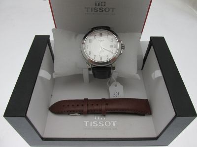 a watch that is in a box with a leather strap