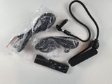 a pair of cables and a remote control on a white table