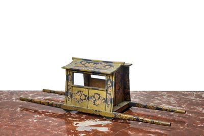 a toy horse drawn carriage sitting on the ground
