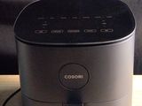 a black speaker sitting on top of a wooden table