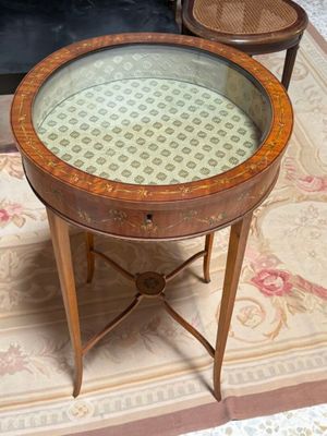 a small table with a glass top on a rug