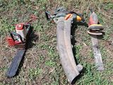 many tools that are laying on the ground in the grass