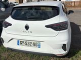 the rear end of a white car parked in a parking lot
