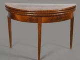 an oval shaped table with a marble top and wooden legs
