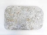 a stone with a design on it sitting on a white surface