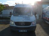 a white van parked in front of a building