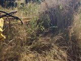 a yellow machine that is sitting in the grass