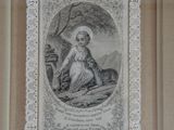 an old picture of a woman sitting on the ground with a dog