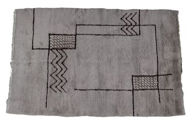 an old rug with a black and white design on it