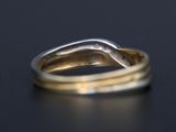 a close up of a gold ring on a black surface