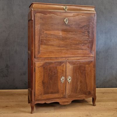 a small wooden cabinet with a door on top of it