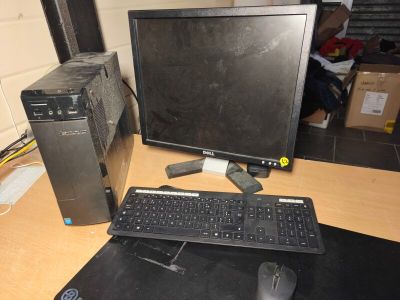 a desktop computer sitting on a desk next to a keyboard and mouse