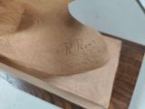 a wooden sculpture of a head on a table