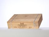 a wooden box with a label on it sitting on a table