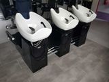three sinks that are sitting in a row in a room