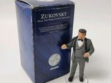 figurine of a man in a tuxedo suit and top hat holding a baseball bat