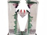 a glass bird feeder with a bird inside of it